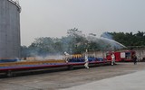 Hình ảnh lính cứu hoả điều khiển xe chữa cháy cần vươn xử lý cháy kho nhiên liệu