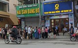 Người dân đội mưa lớn, xếp hàng chờ mua vàng miếng ở Hà Nội