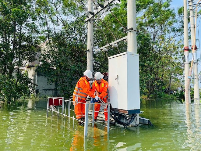 Nâng cáp ngập lên khỏi mặt nước, vệ sinh lau dọn mặt máy để sẵn sàng cấp điện trở lại khi nước rút (Trạm biến áp Hòa Thạch lúc 9h00 ngày 14/9/2024)