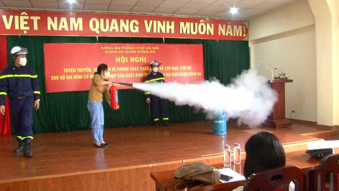 Đại diện các hộ gia đình kết hợp sản xuất, kinh doanh thực hành thao tác chữa cháy Đại diện các hộ gia đình kết hợp sản xuất, kinh doanh thực hành thao tác chữa cháy