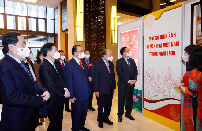 Các đồng chí lãnh đạo, nguyên lãnh đạo Đảng, Nhà nước và các đại biểu tham quan, nghe giới thiệu về Triển lãm “Văn hóa soi đường cho quốc dân đi”